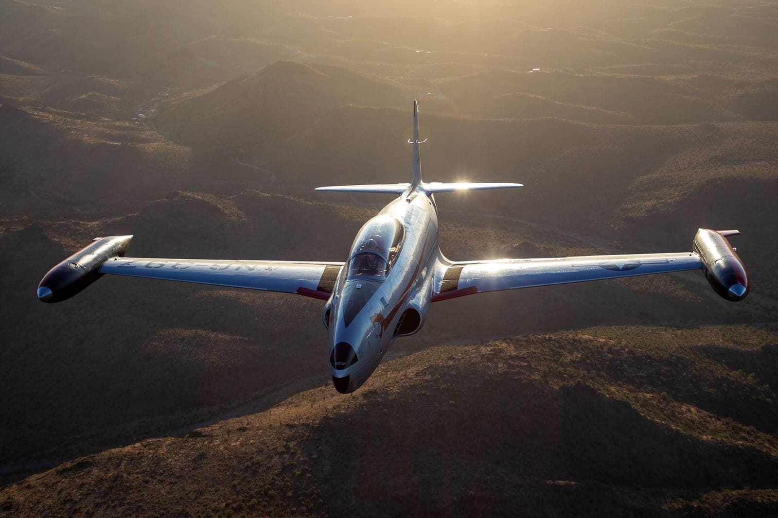 The AAHG T-33 in The Copperheads livery, air-to-air at sunset.